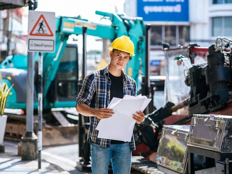 Civil engineers work on large road and machinery conditions.