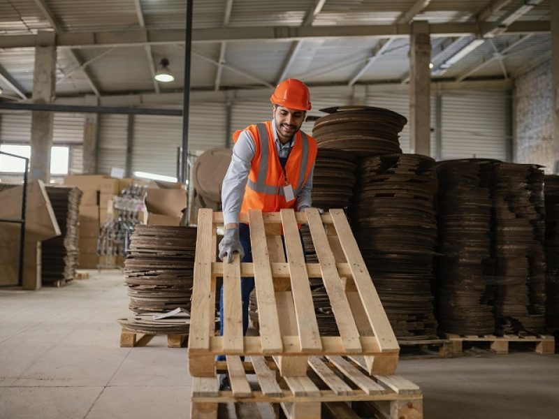man-working-with-heavy-wooden-materials