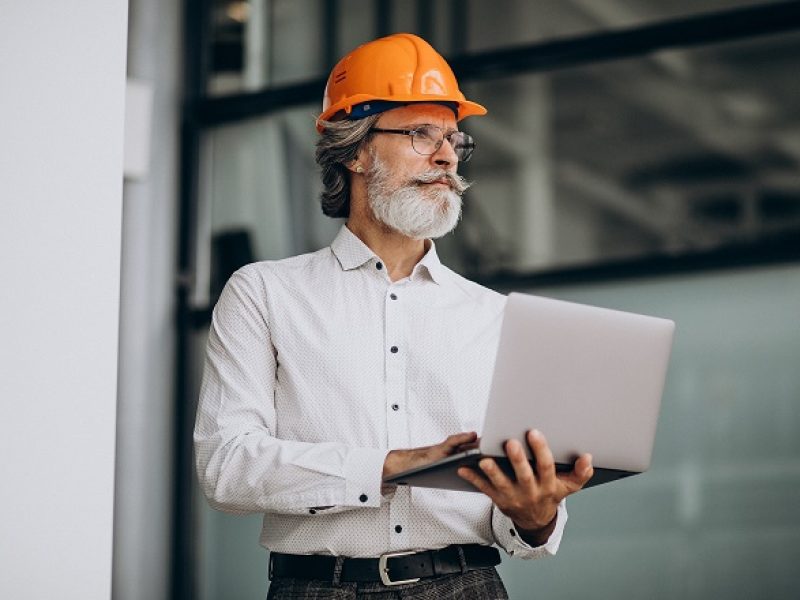 Middle aged business man in a hard hat