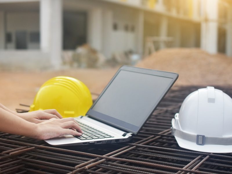 Engineering use computer at work building construction background